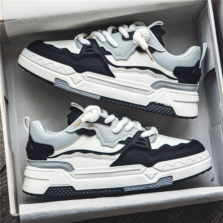 Pair of black and white sneakers in an open box