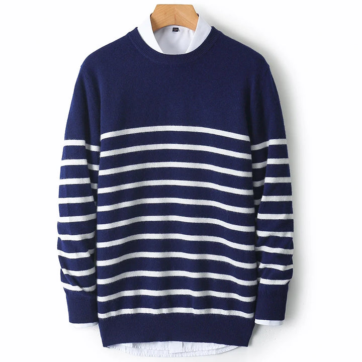 Navy blue and white striped sweater on a wooden hanger against a white background