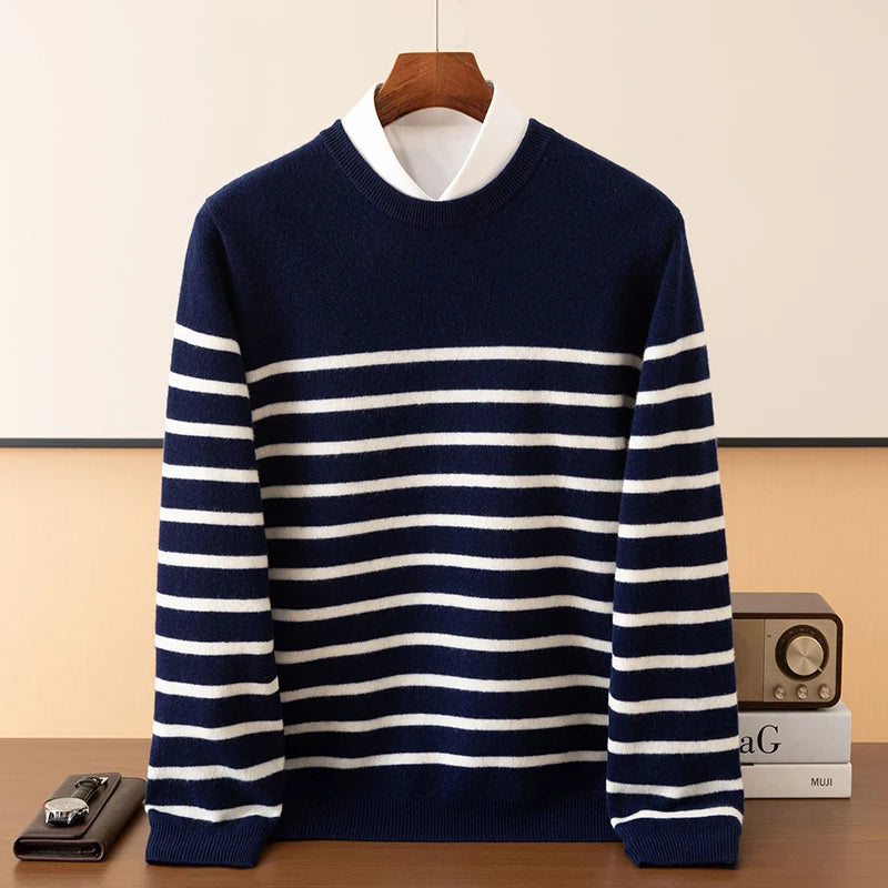 Navy and white striped sweater on a wooden hanger against a beige background
