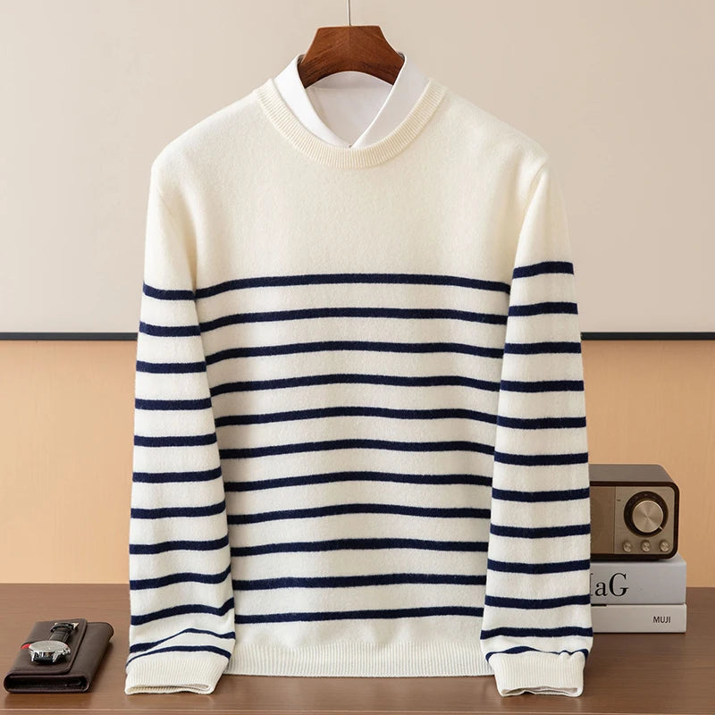White sweater with blue stripes on a wooden hanger against a beige background