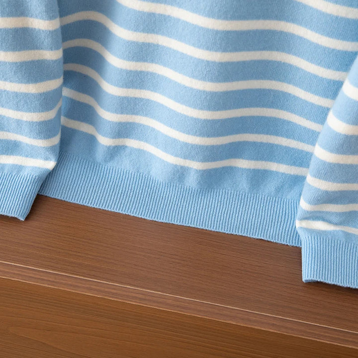 Close-up of a blue and white striped fabric on a wooden surface