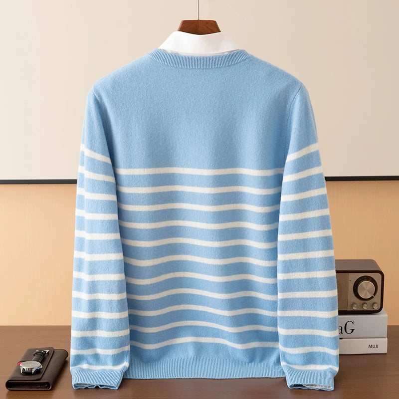 Blue and white striped sweater on a hanger against a beige wall.