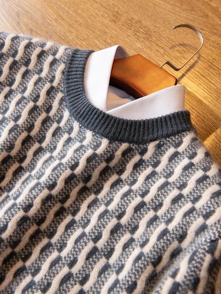 Patterned sweater on a wooden hanger against a wooden floor background