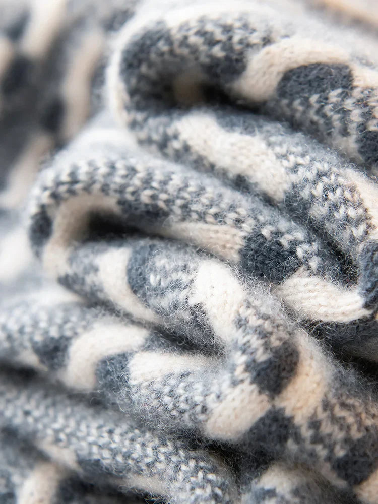 Close-up of a knitted fabric with black, white, and gray pattern