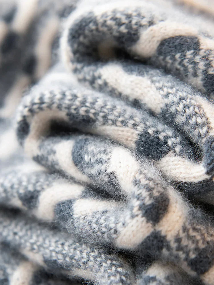 Close-up of a knitted fabric with black, white, and gray pattern