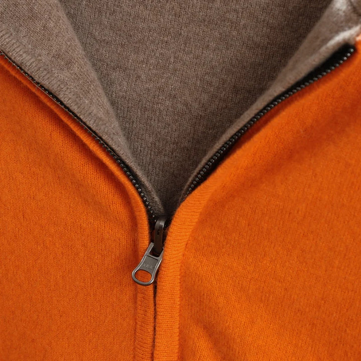 Close-up of a zipper on an orange and gray jacket