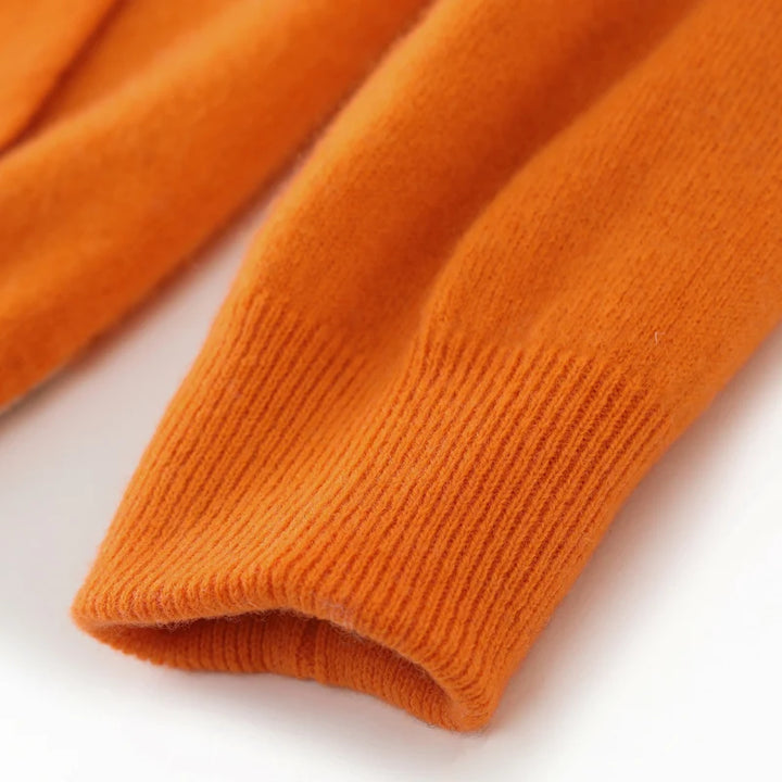 Close-up of orange knitted fabric on a white background