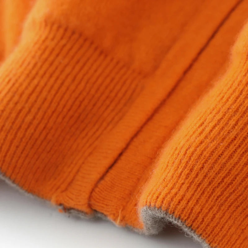 Close-up of orange fabric with a textured pattern on a white background