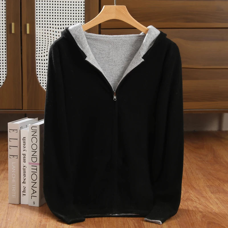 Black hoodie with gray lining on a wooden hanger against a wooden background