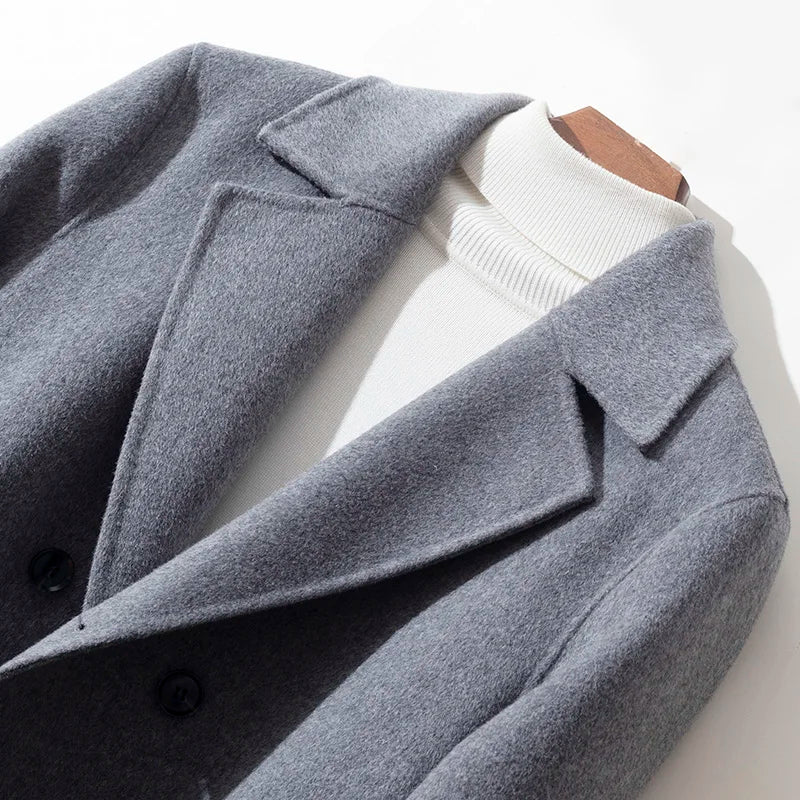 Gray coat with a white shirt underneath on a light background