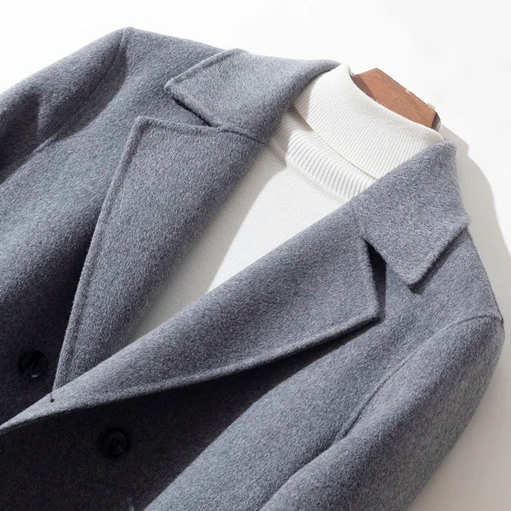 Gray coat with a white shirt underneath on a light background