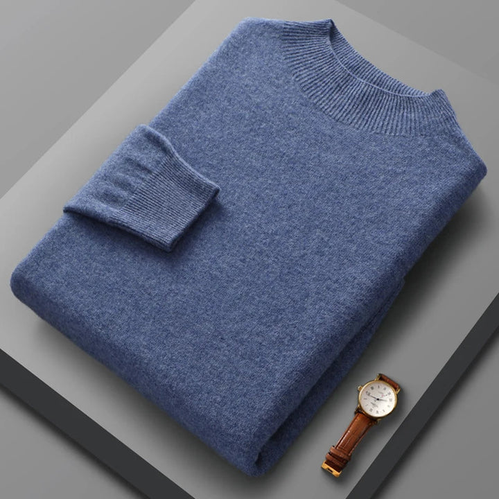 Blue sweater and watch on a gray surface
