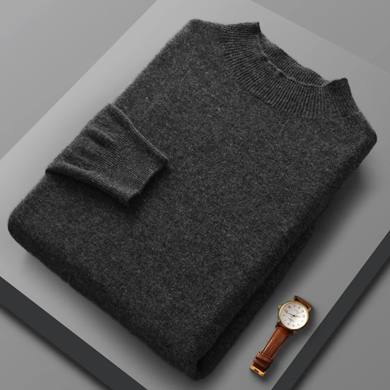 Gray sweater and watch on a gray surface