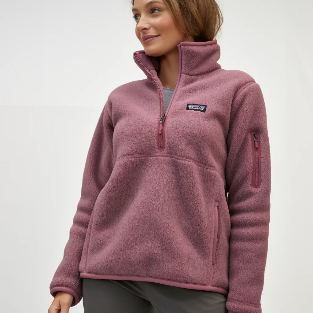 Woman wearing a pink fleece pullover with a brand logo on a white background