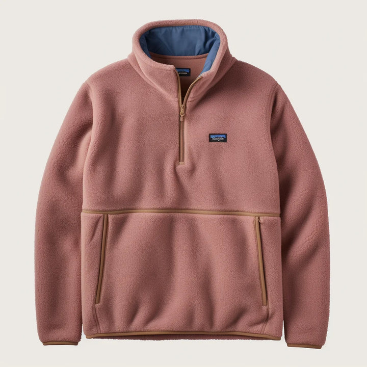 Pink fleece pullover with a brand logo on a beige background