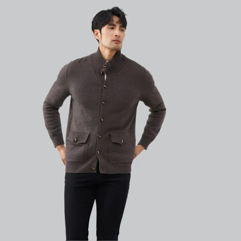 Man wearing a brown cardigan on a gray background