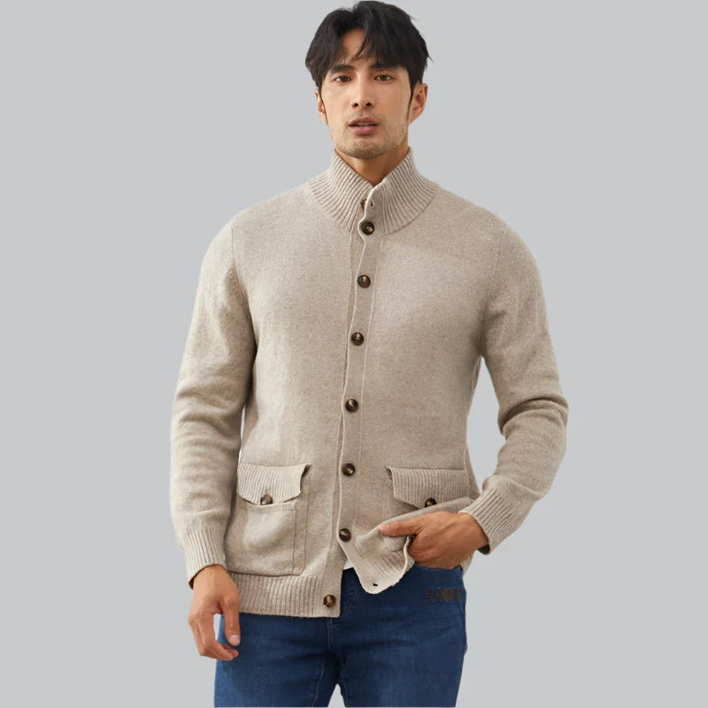 Man wearing a beige cardigan with brown buttons on a gray background