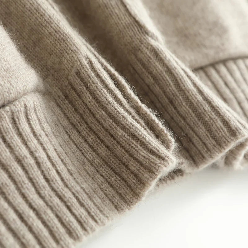 Close-up of a beige knitted sweater on a white background