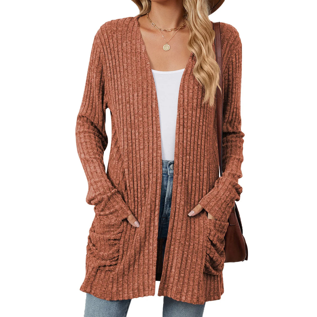 Brown ribbed cardigan worn by a person on a white background