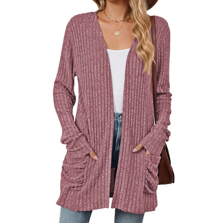 Pink ribbed cardigan worn by a person on a white background