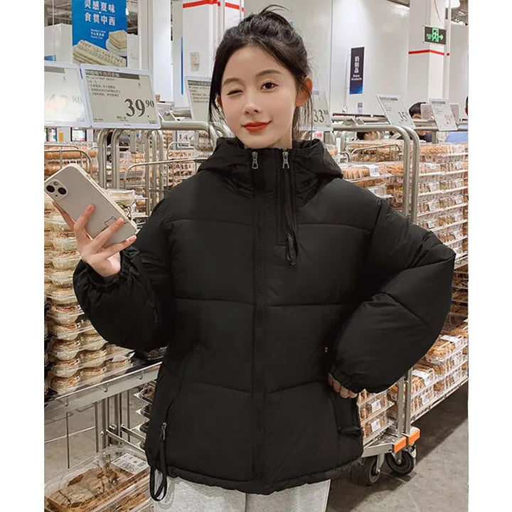 Person wearing a black puffer jacket in a store setting