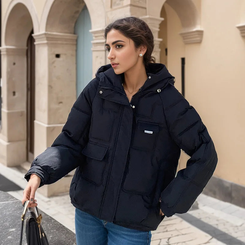 Woman wearing a black puffer jacket in an urban setting