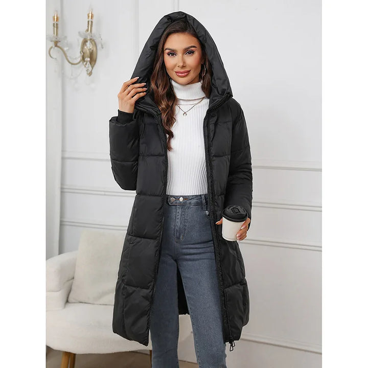 Woman wearing a black puffer coat in an indoor setting