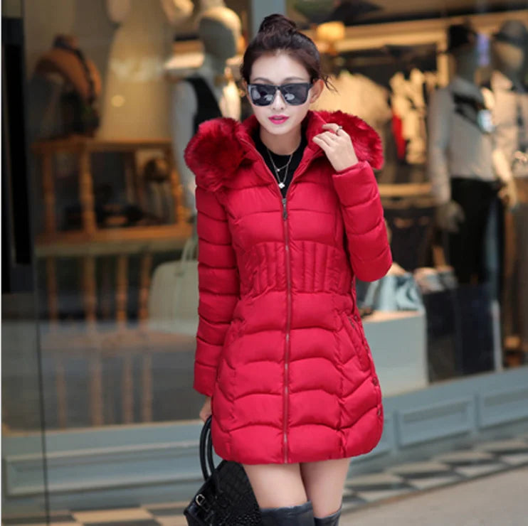 Woman wearing a red puffer coat in an indoor setting