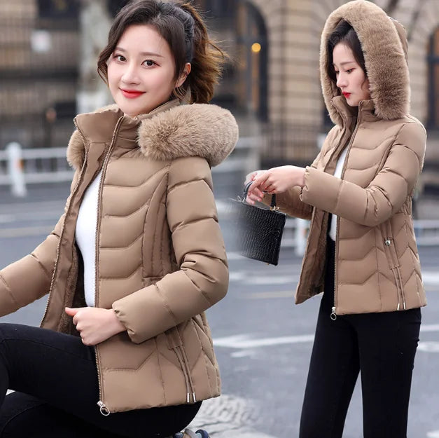 Woman wearing a beige puffer jacket with fur hood on a city street.