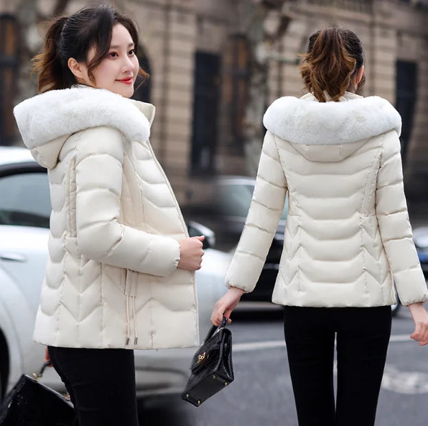 Woman wearing a white puffer jacket with fur hood, shown from front and back, on a city street.