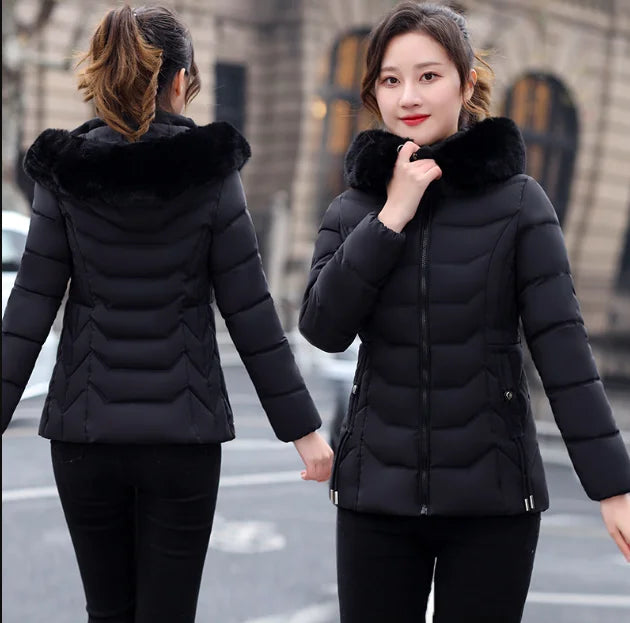 Woman wearing a black puffer jacket with fur hood in an urban setting