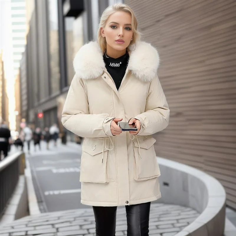 Woman wearing a beige coat with fur collar on a city street
