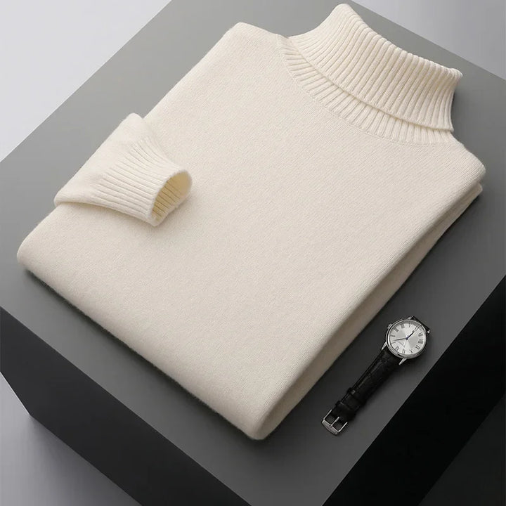 Beige sweater and watch on a dark surface