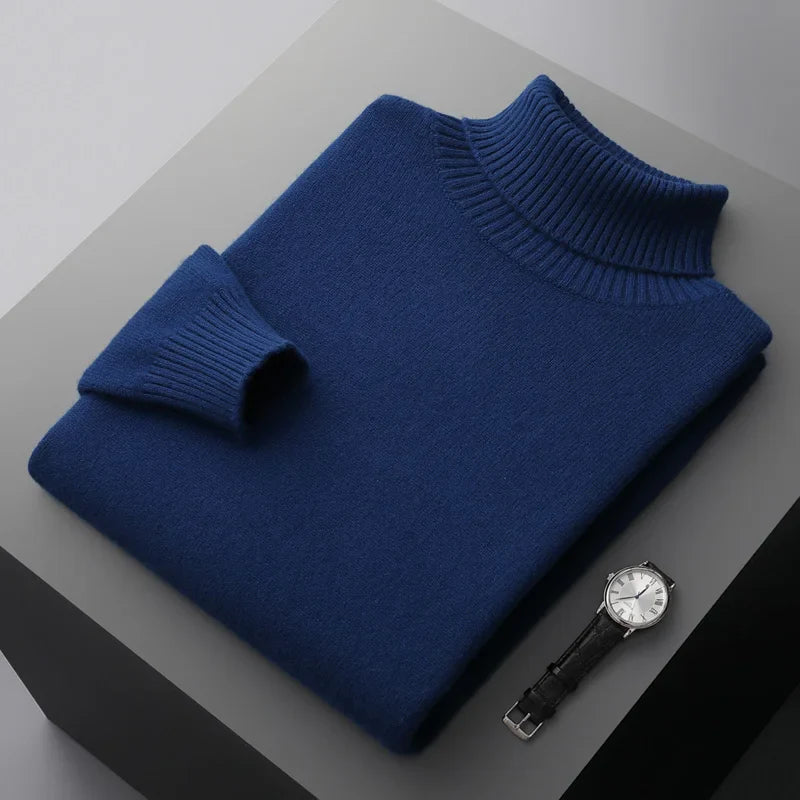 Blue turtleneck sweater and watch on a gray surface