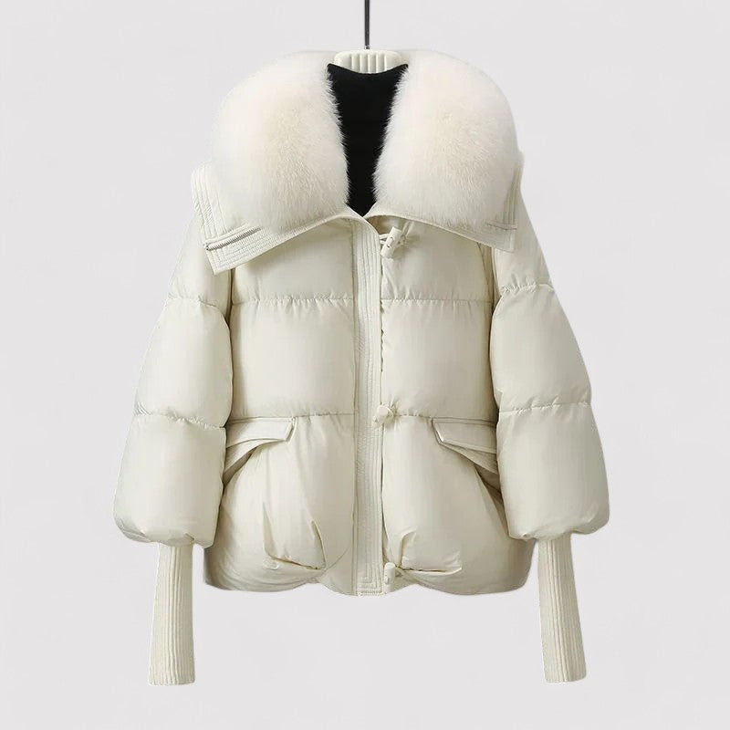 White puffer jacket with fur-lined hood on a light gray background