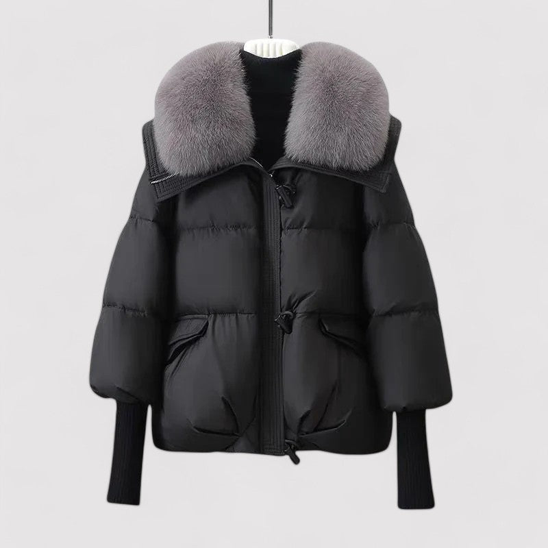 Black puffer jacket with gray fur collar on a white background