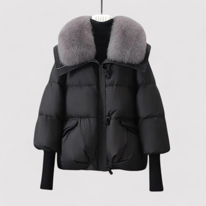 Black puffer jacket with gray fur collar on a white background