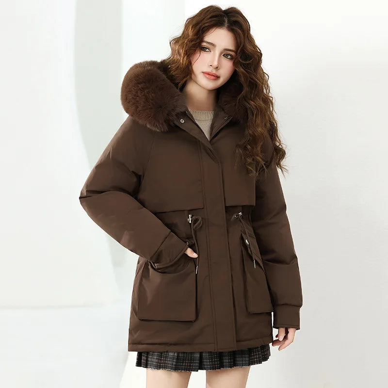 Woman wearing a brown coat with fur hood on a white background