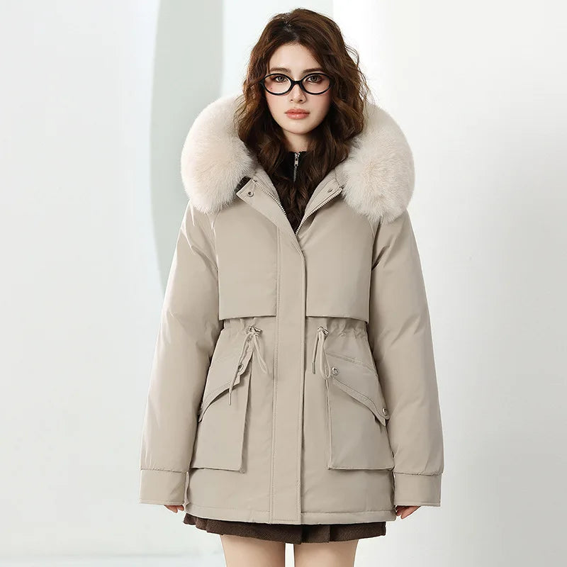 Woman wearing a beige parka with a fur-lined hood on a white background