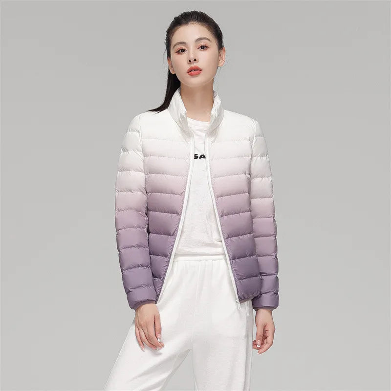 Woman wearing a gradient purple and white puffer jacket on a gray background