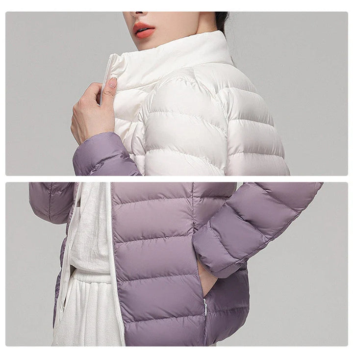 White and purple puffer jacket with a gray background
