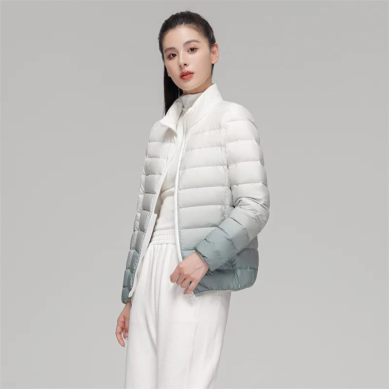 Woman wearing a white puffer jacket against a gray background