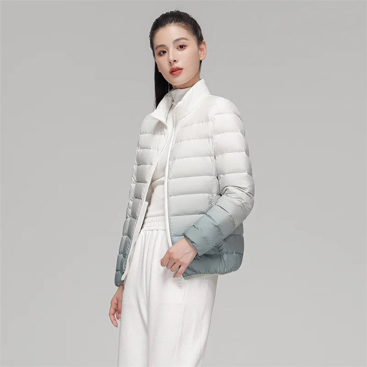 Woman wearing a white puffer jacket against a gray background