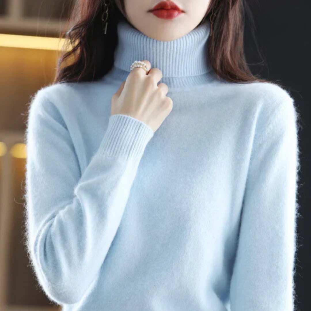 Light blue turtleneck sweater worn by a person with a blurred background