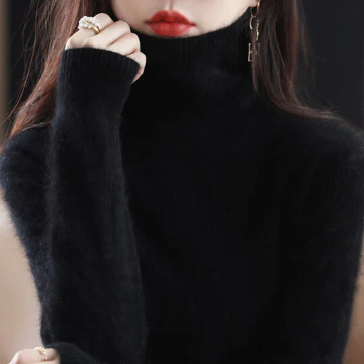 Person wearing a black turtleneck sweater with a blurred background