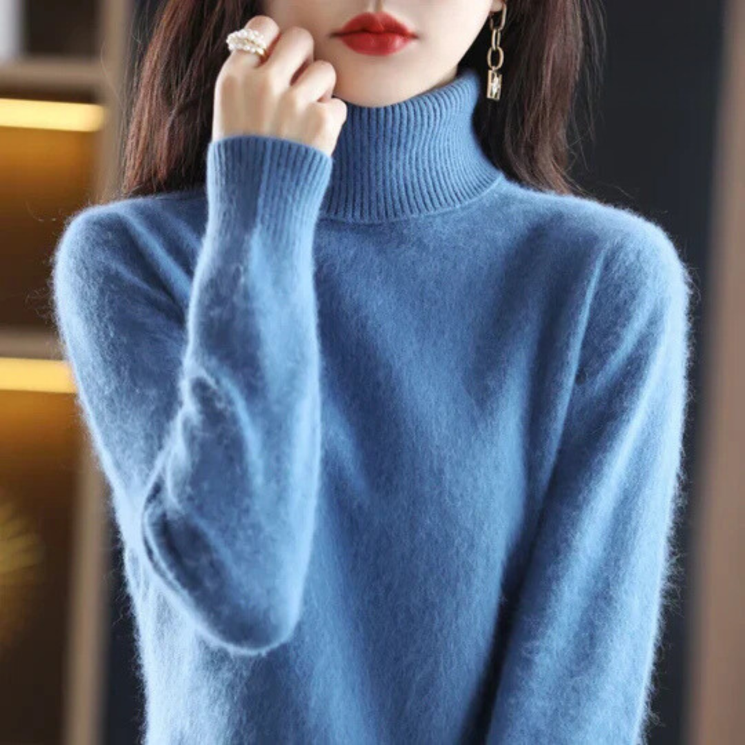 Blue turtleneck sweater worn by a person with a blurred background