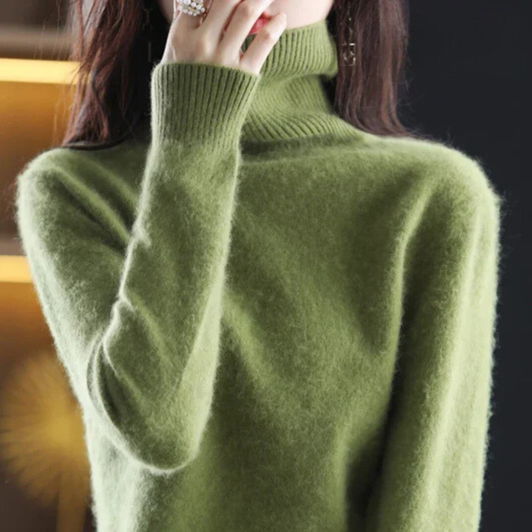 Green turtleneck sweater worn by a person with a blurred background