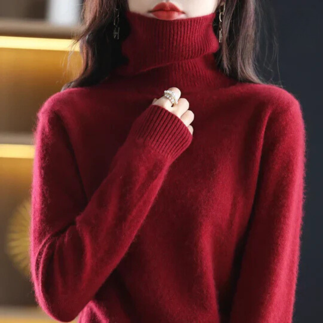 Person wearing a red turtleneck sweater with a blurred background