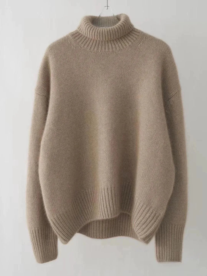 Beige sweater on a hanger against a white background