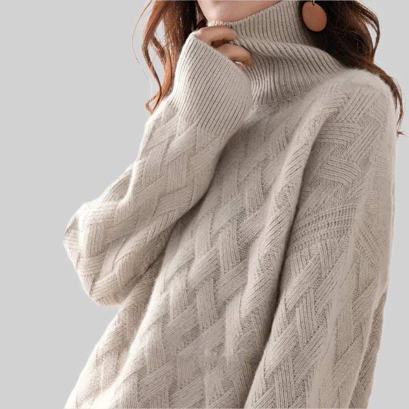 Beige turtleneck sweater worn by a person on a light gray background